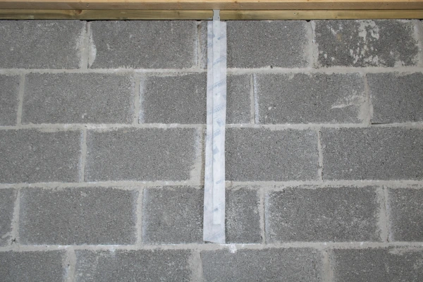 Contega Solido tape over a wall bracket on a masonry wall.