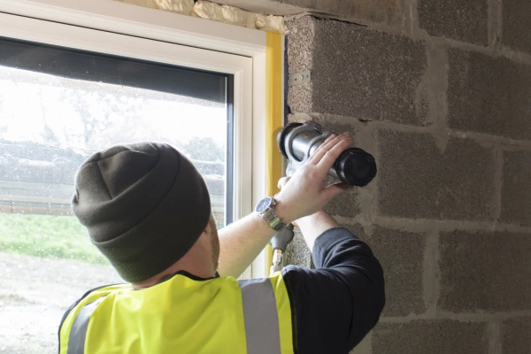 The Aerofixx sprayer being use to seal a window to wall junction