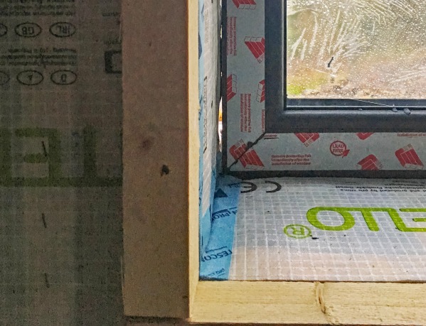 The corner junction of a window with Tescon Profil airtight tape sealing the vapour control membrane to the timber frame