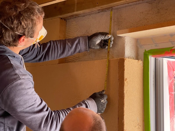 Gutex Thermoroom woodfibre boards being fitted over Diasen Thermactive cork lime thermal plaster.