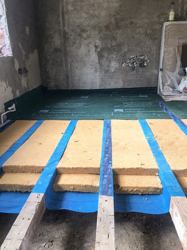 Suspended timber floor with Gutex insulation and membranes.