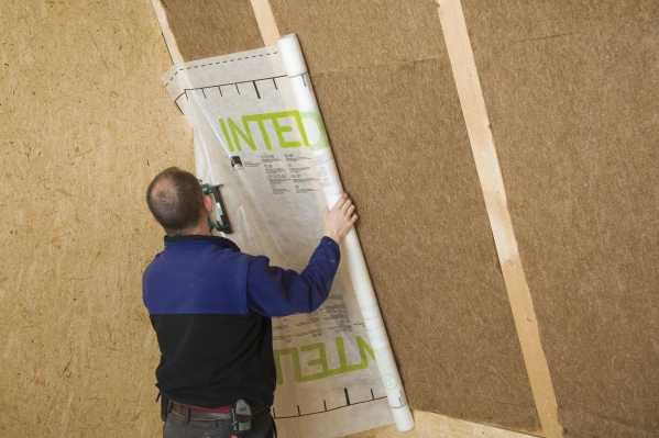 Intello airtight membrane being applied over Thermo Hemp insulation