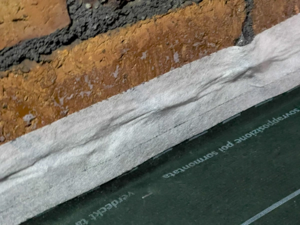 Fig. 13 h. Contega Solido SL airtight tape used with Tescon Sprimer (airtight primer) to seal Dasatop membrane to gable/party wall.