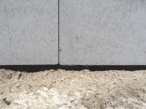 Fiden Exo gap filling expanding tape perfectly seals an uneven gap where the insulation boards meet the floor