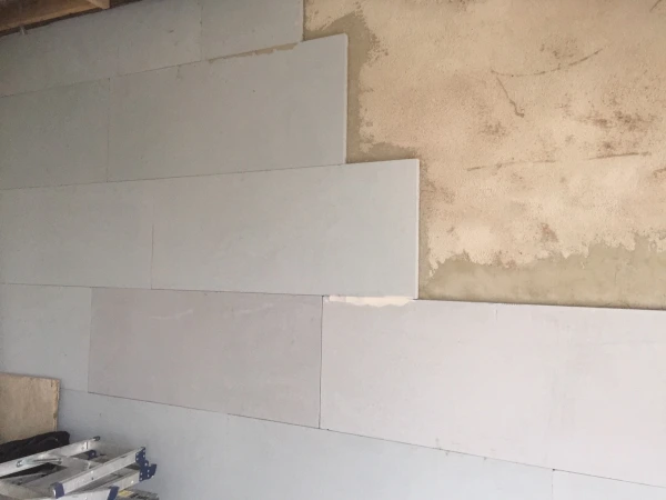 Calsitherm insulation boards fitted to a wall which has been leveled with Diasen plaster