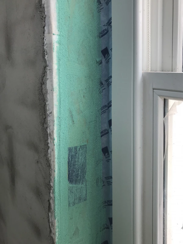 Aquabond painted over the the smooth surface around a window frame.