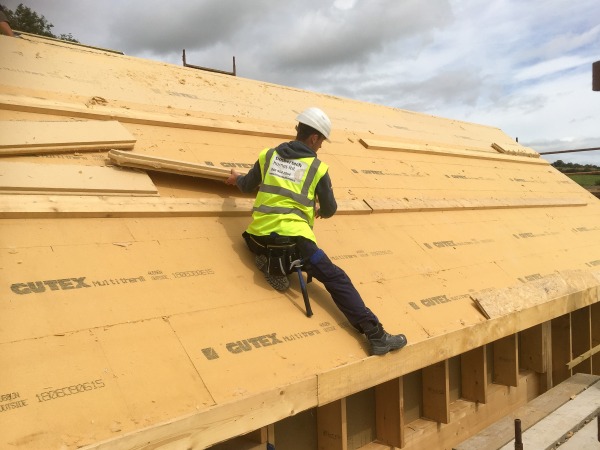 Multitherm to a pitched roof temporarily restrained with timber battens and mechanical fixings