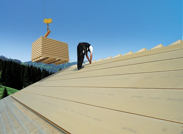 Roof completley fitted with Ultratherm panels with an installer working on the finishing touches