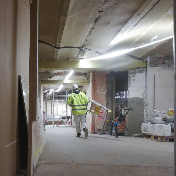 Strip lighting being used to light up a hallway on a building site