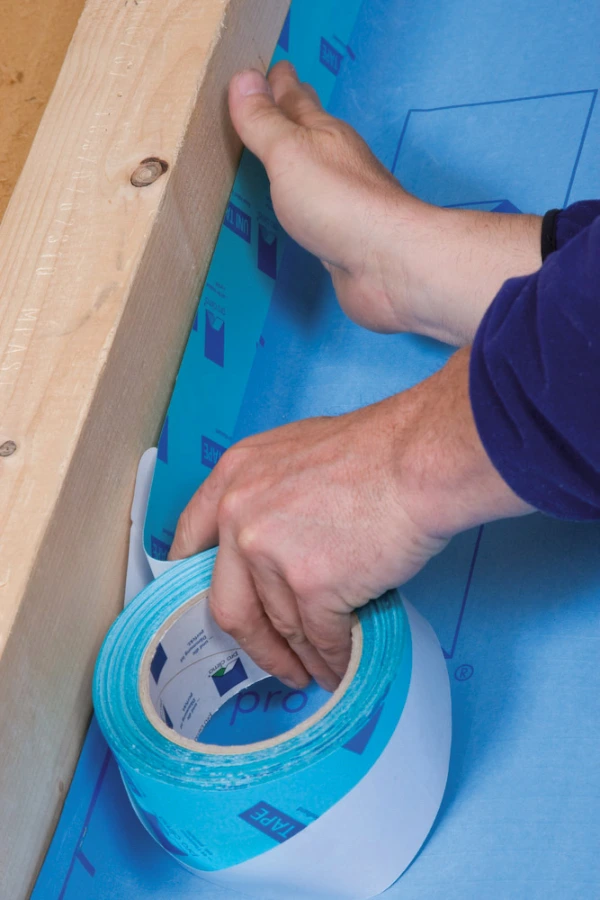 Pro Clima Unitape being used to stick a DB+ membrane to a joist