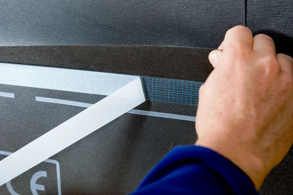 Duplex release paper being removed after being stuck to a membrane