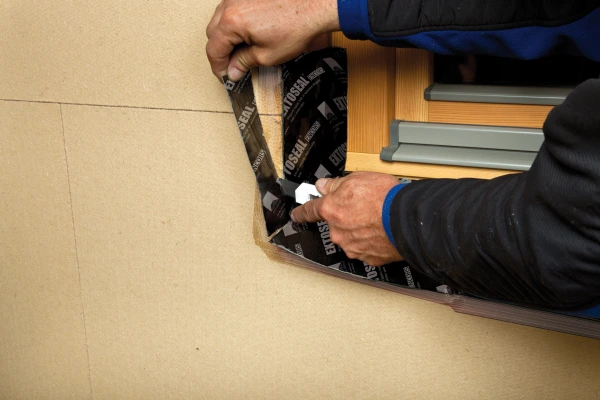 Trimming the edge of Extoseal Encors so that it is flush with the external finish