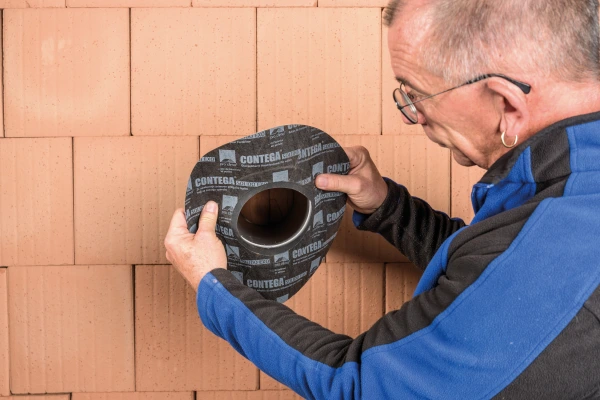 Roflex Solido grommet being fitted over a pipe