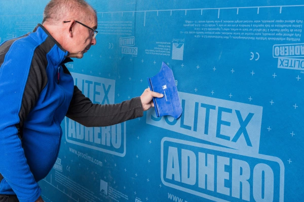 A PressFix XL tool firmly pressing Adhero to the wall surface