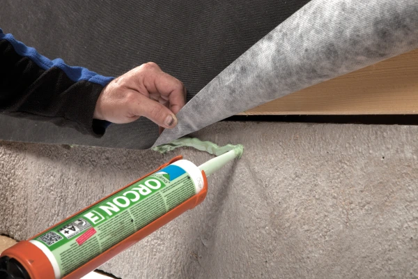 Orcon F being used to seal Solitex Fronta Quattro to masonry