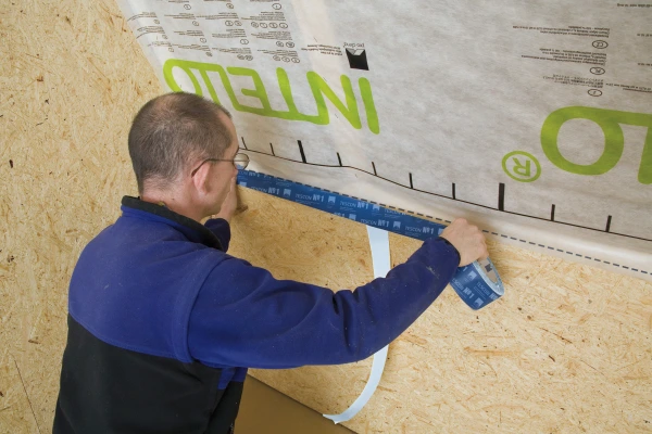 Tescon No.1 sealing an Intello airtight membrane over a wood-based board