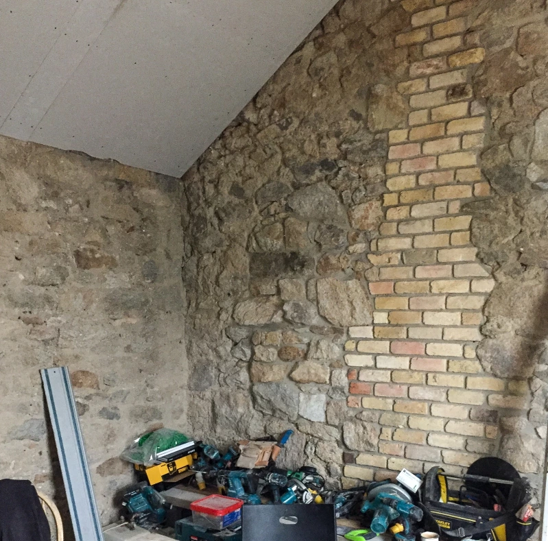 Internal granite wall after gap was infilled with bricks