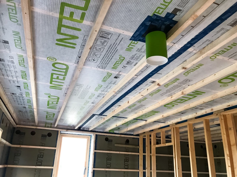 Intello airtight membrane on ceiling with pipe fitted with airtight grommet