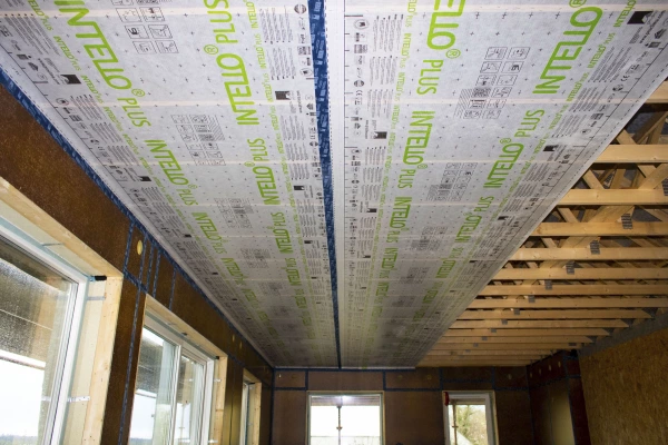Intello Plus during installation on a ceiling, bonded to Finsa airtight racking boards on the walls.