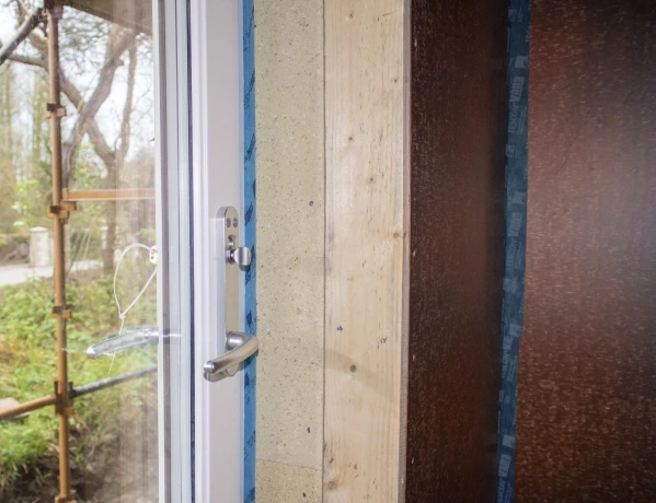 Bosig structural insulation board with Tescon Profil airtight tape on a door frame