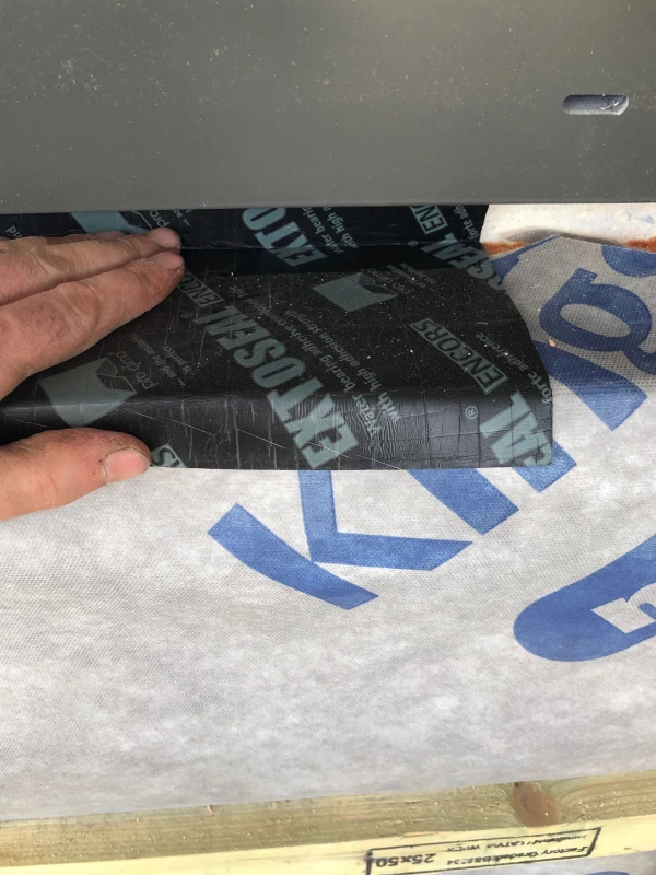 Extoseal Encors window sealing tape on the outside of a window reveal