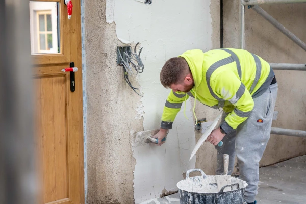 Diasen Argatherm finishing plaster being plastered over an undercoat of Diathonite Thermactive near a door