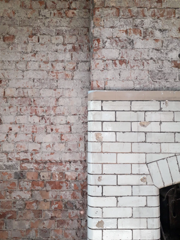 Exposed brickwork around a fireplace
