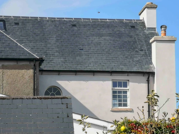 A view of the back of 58 Burrin Street showing an arched window and a Georgian window