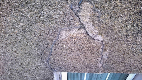 Cracks in the wall above window 