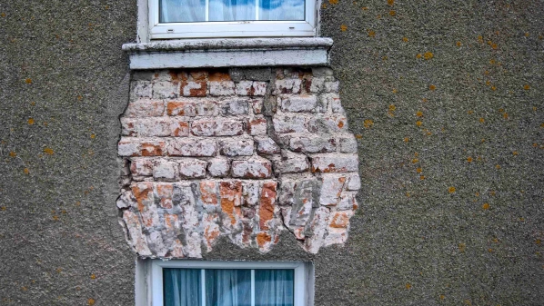 Exposed brickwork between windows on upper and lower floors