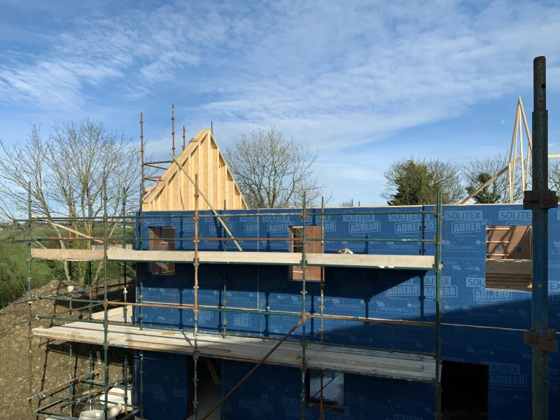 A view from the second story of scaffolding of Solitex Adhero on the exterior of the timber frame