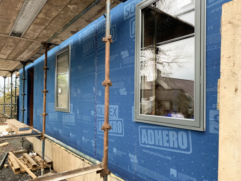 Solitex Adhero peel and stick membrane on a timber frame wall with scaffolding in the foreground