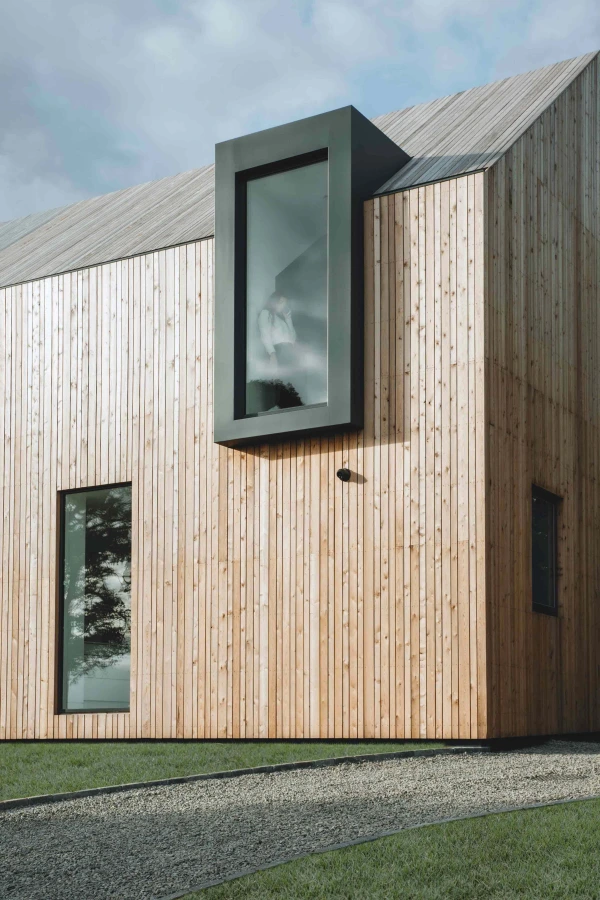 A prominent window jutting out from the timber frame